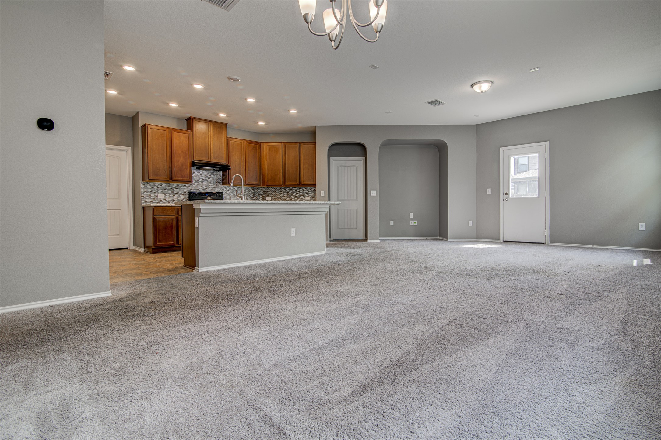 1916 Dragonfly Loop Bastrop, TX 78602 - Photo 7 of 33 a view of an empty room with a kitchen