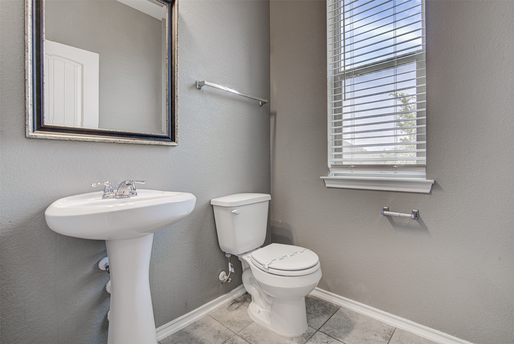 1916 Dragonfly Loop Bastrop, TX 78602 - Photo 9 of 33 a bathroom with a sink a mirror and a toilet
