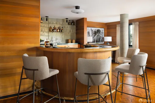 a dining room with chairs and wooden floor