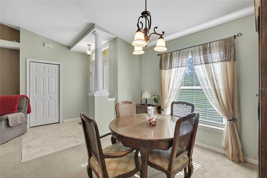 15157 Duck Hawk Road Weeki Wachee, FL 34614 - Photo 14 of 48 a view of a dining room with furniture window and wooden floor