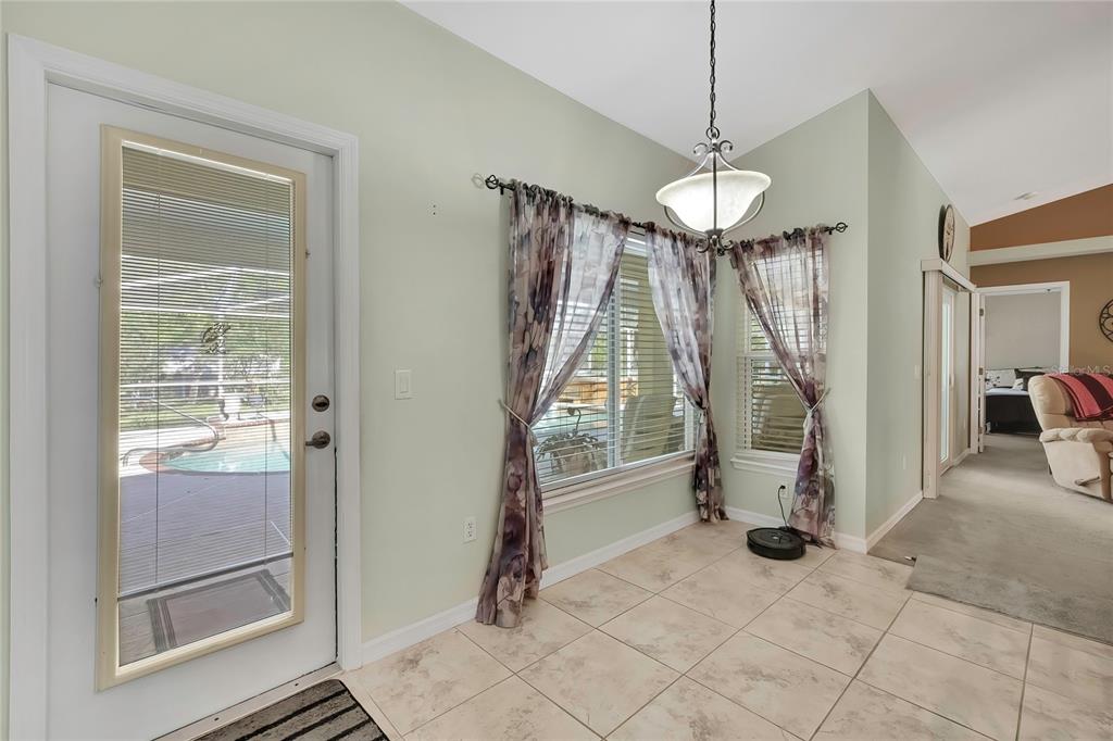 15157 Duck Hawk Road Weeki Wachee, FL 34614 - Photo 16 of 48 a view of a livingroom with a floor to ceiling window and entryway