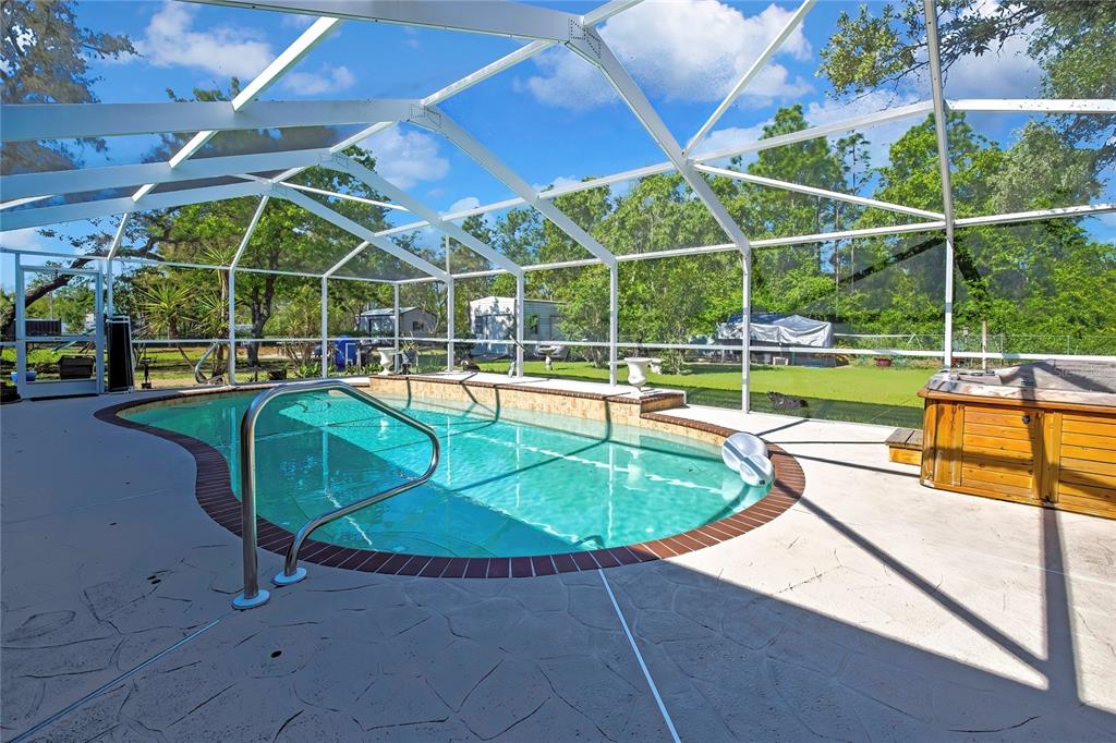 15157 Duck Hawk Road Weeki Wachee, FL 34614 - Photo 2 of 48 a view of a backyard with swimming pool