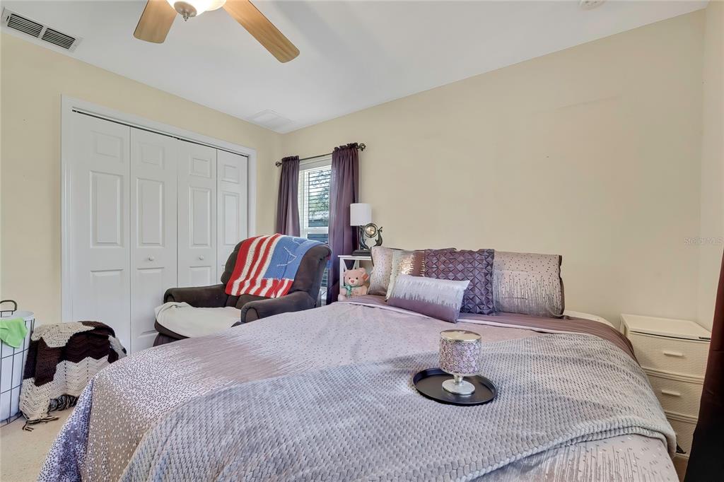 15157 Duck Hawk Road Weeki Wachee, FL 34614 - Photo 25 of 48 a bedroom with a bed and a chandelier