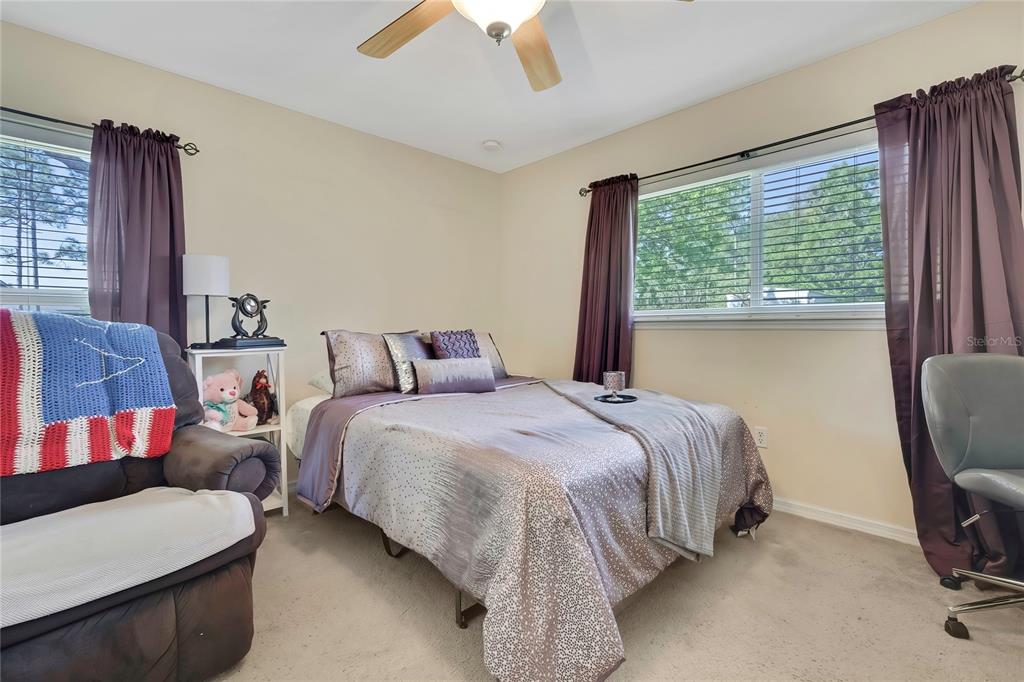 15157 Duck Hawk Road Weeki Wachee, FL 34614 - Photo 26 of 48 a bed sitting in a bedroom next to a window