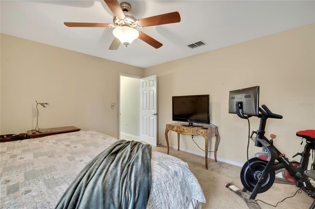 15157 Duck Hawk Road Weeki Wachee, FL 34614 - Photo 28 of 48 a bedroom with a bed and a flat screen tv