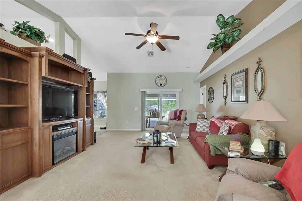15157 Duck Hawk Road Weeki Wachee, FL 34614 - Photo 3 of 48 a living room with furniture and a flat screen tv