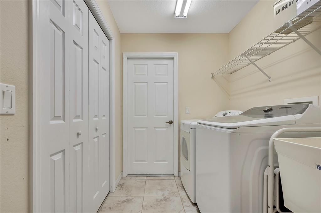 15157 Duck Hawk Road Weeki Wachee, FL 34614 - Photo 32 of 48 a storage room with washer and dryer