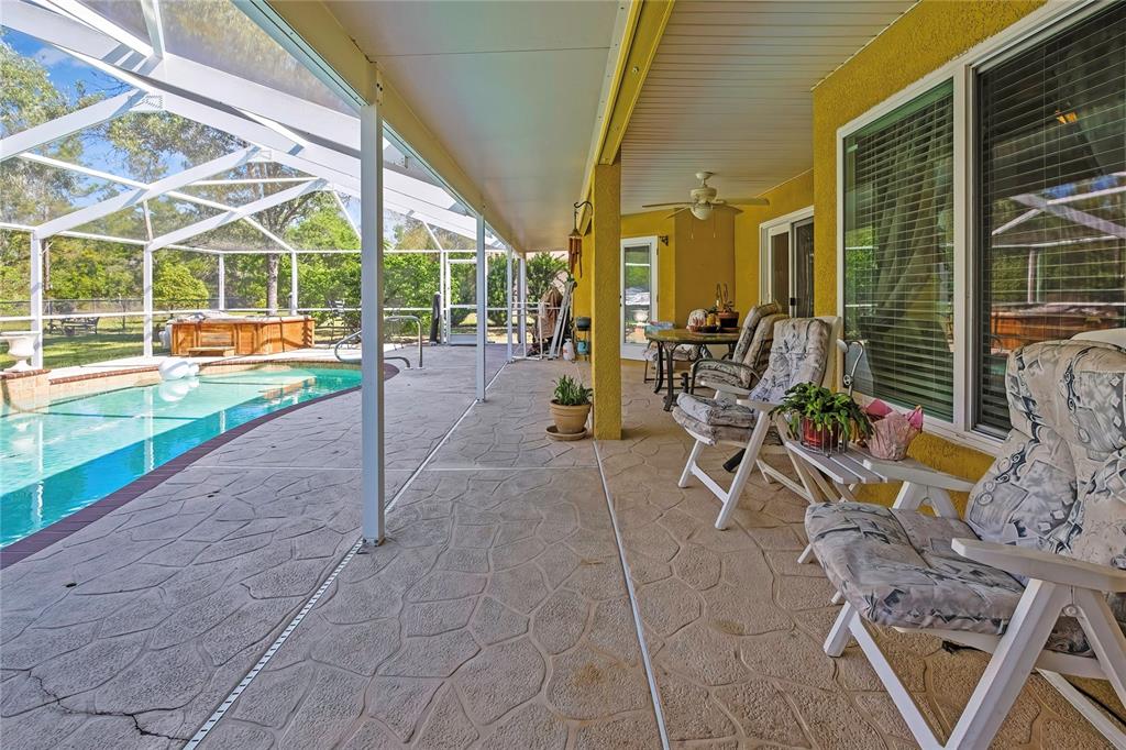 15157 Duck Hawk Road Weeki Wachee, FL 34614 - Photo 37 of 48 a view of a patio with a table and chairs and potted plants