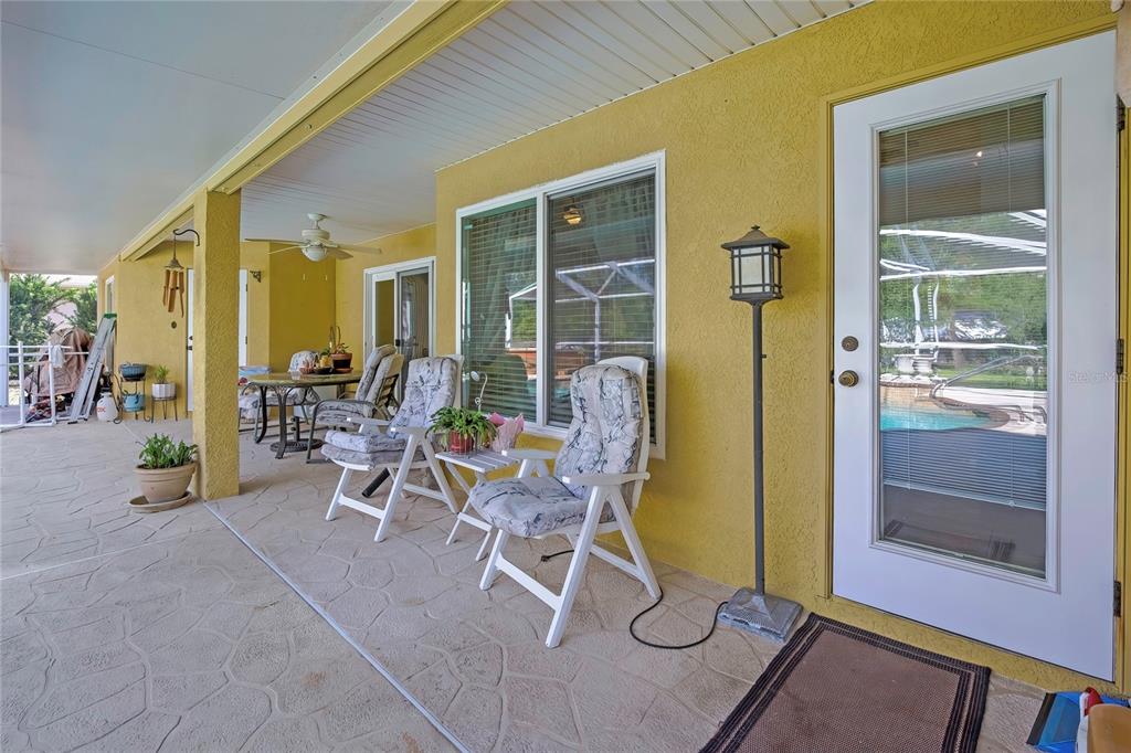 15157 Duck Hawk Road Weeki Wachee, FL 34614 - Photo 38 of 48 a view of a patio with table and chairs and potted plants