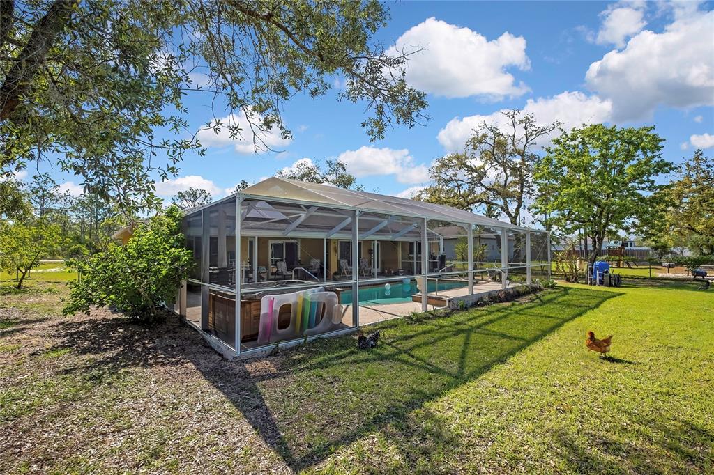 15157 Duck Hawk Road Weeki Wachee, FL 34614 - Photo 43 of 48 a view of a house with backyard and sitting area