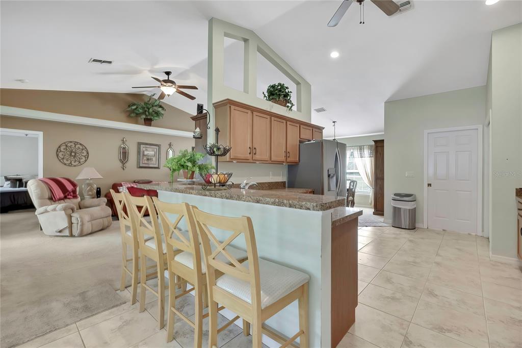 15157 Duck Hawk Road Weeki Wachee, FL 34614 - Photo 6 of 48 a very nice looking dining room with kitchen island granite countertop furniture a rug and a chandelier