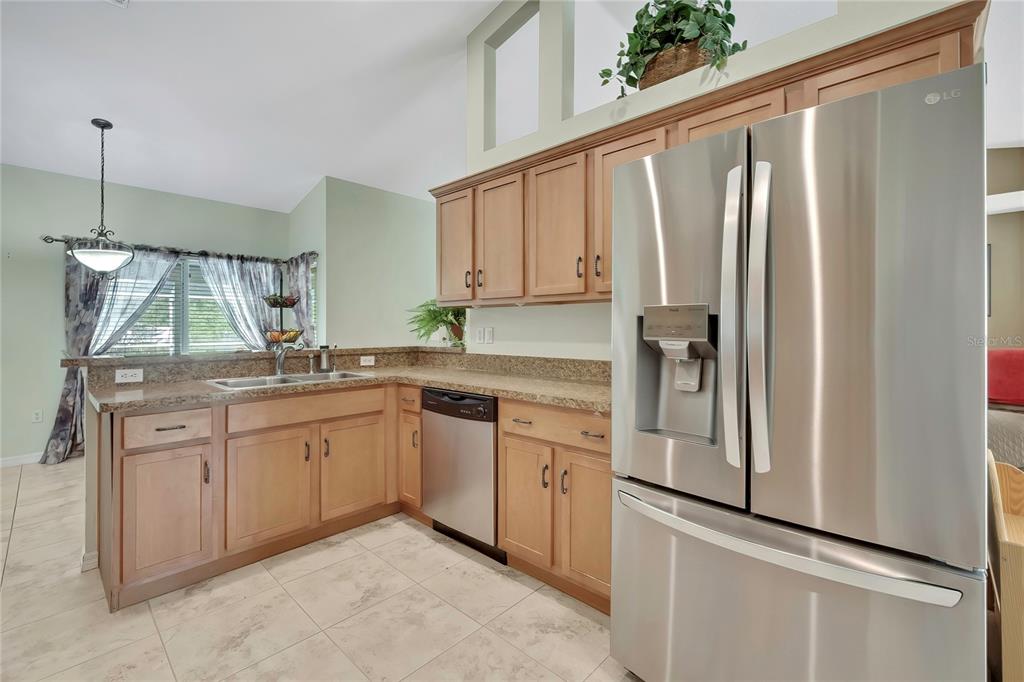 15157 Duck Hawk Road Weeki Wachee, FL 34614 - Photo 7 of 48 a kitchen with stainless steel appliances granite countertop a refrigerator and a sink
