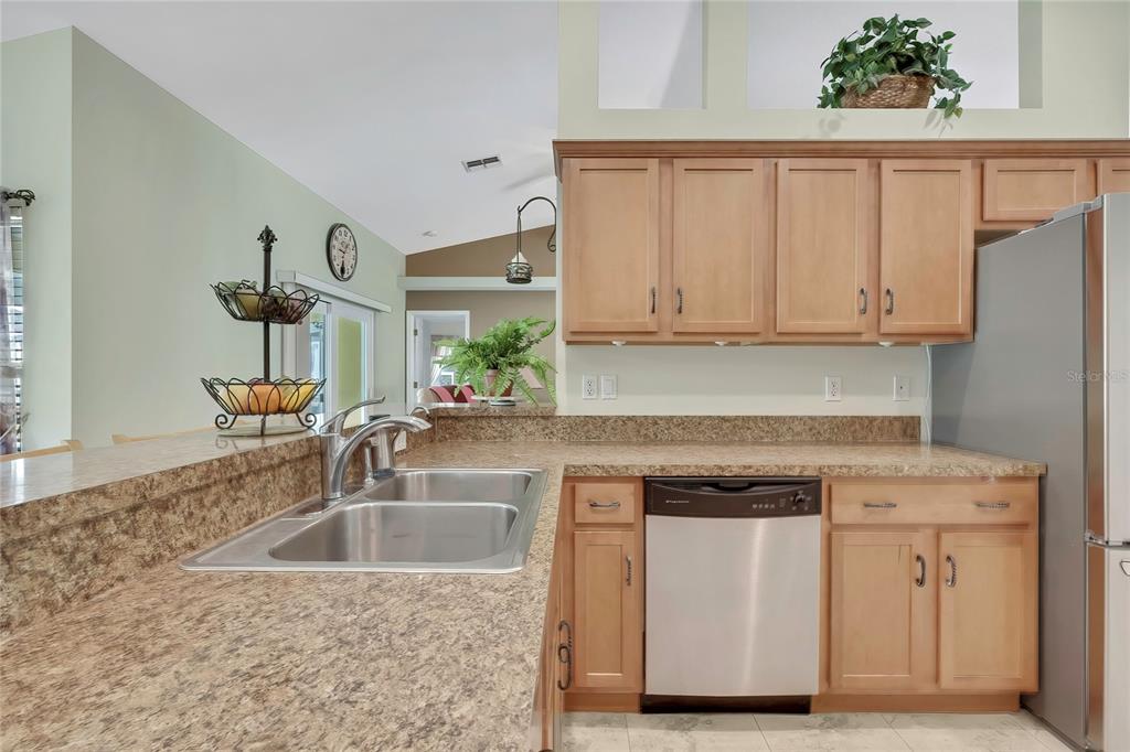 15157 Duck Hawk Road Weeki Wachee, FL 34614 - Photo 9 of 48 a kitchen with granite countertop a sink dishwasher stove and cabinets