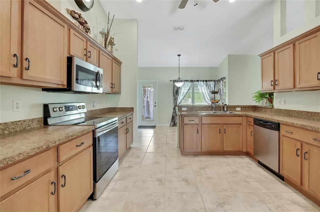 15157 Duck Hawk Road Weeki Wachee, FL 34614 - Photo 10 of 48 a kitchen with stainless steel appliances granite countertop a sink and cabinets