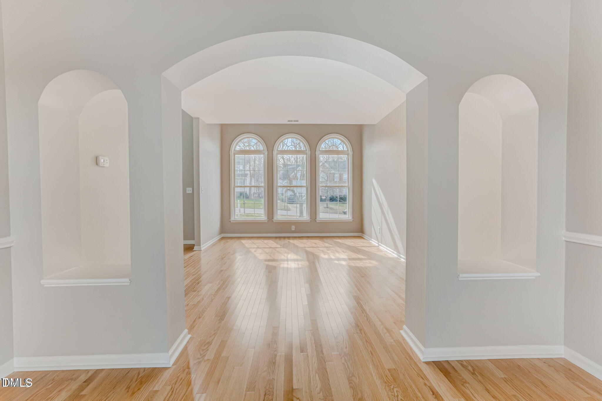 480 Seastone Street Raleigh, NC 27603 - Photo 9 of 26 an empty room with wooden floor and windows