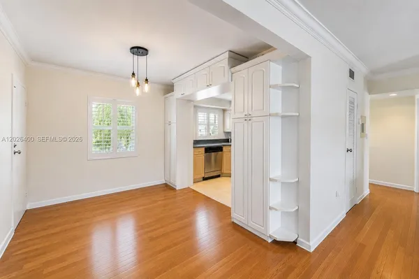 a view of a kitchen with wooden floor and a kitchen