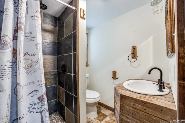 a bathroom with a sink toilet and shower