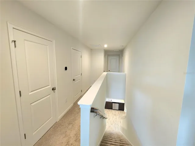 a view of a hallway with stairs