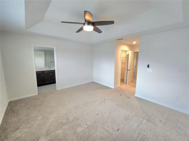 a view of empty room with ceiling fan