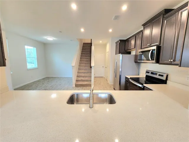 a view of a living room with stainless steel appliances