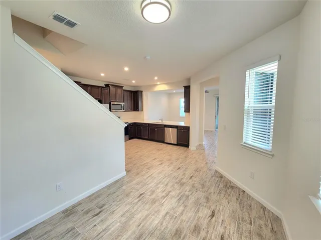 a view of a kitchen with a sink and a window
