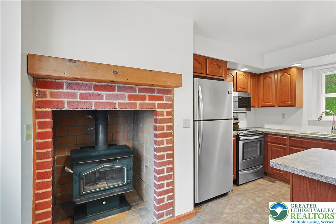 337 West Main Street Bath, PA 18014 - Photo 12 of 32 a kitchen with stainless steel appliances a refrigerator and a stove top oven