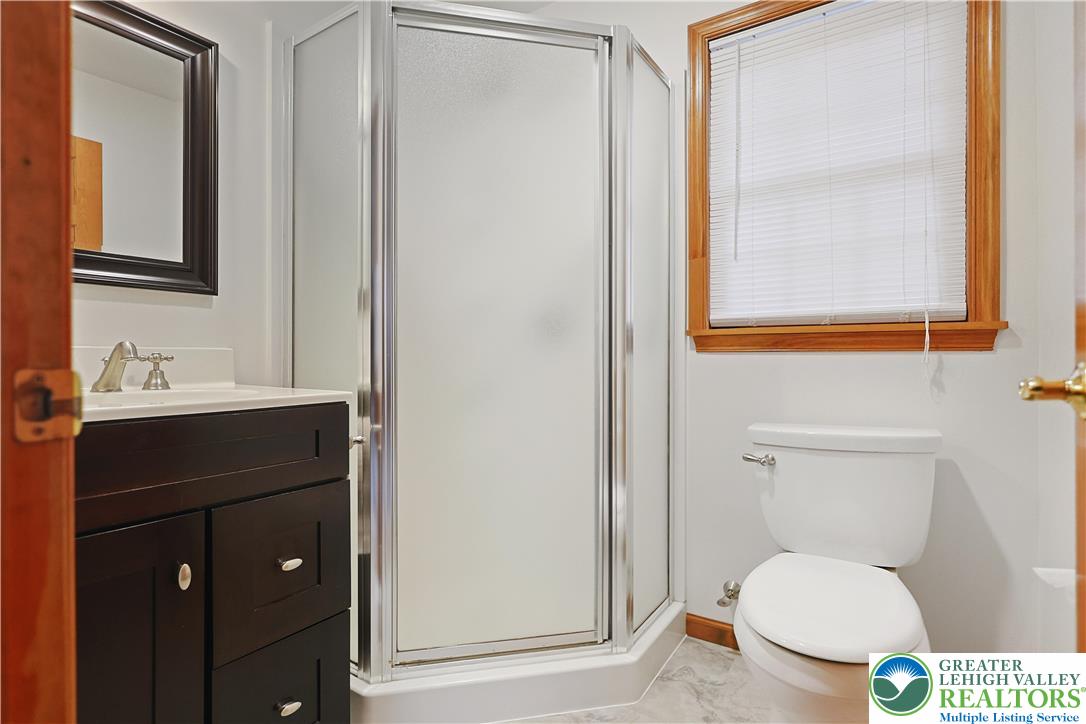 337 West Main Street Bath, PA 18014 - Photo 18 of 32 a bathroom with a toilet a sink and mirror