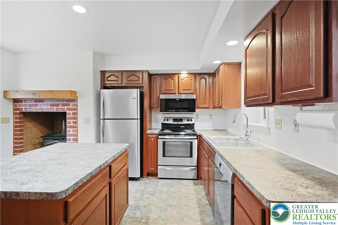 337 West Main Street Bath, PA 18014 - Photo 10 of 32 a kitchen with stainless steel appliances granite countertop a sink stove microwave and refrigerator