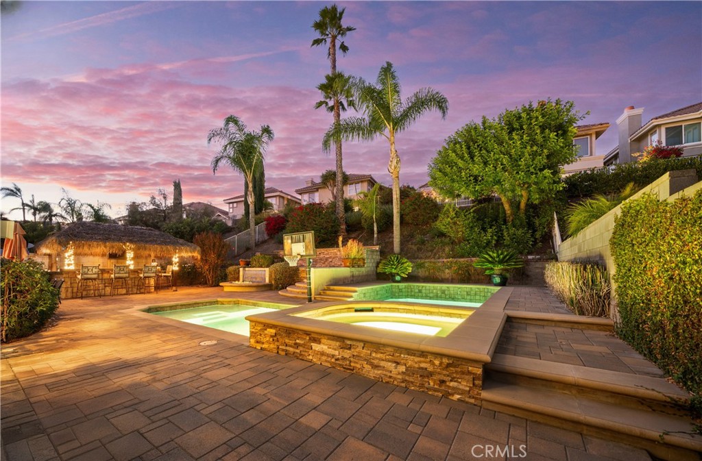 a view of swimming pool with outdoor seating and city view