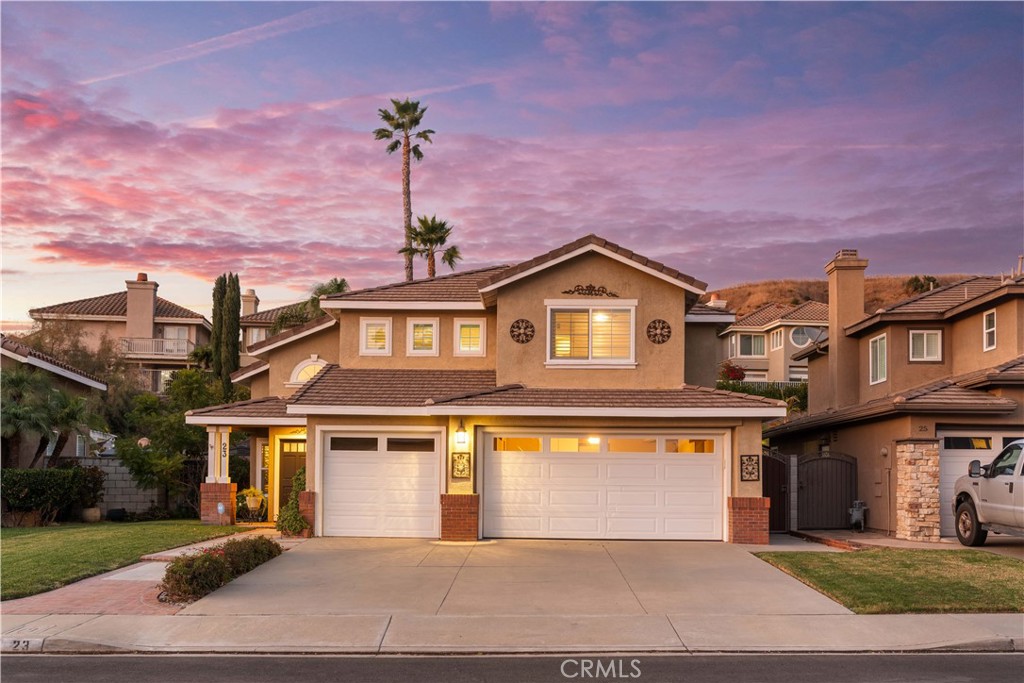 23 Yellowpine Lane Trabuco Canyon, CA 92679 - Photo 4 of 22 a front view of a house with a yard and garage