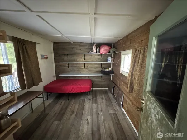 a view of a room with wooden floor