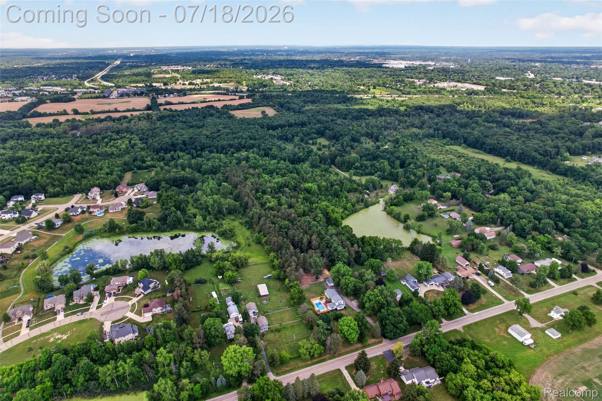 1437 East Cook Road Grand Blanc, MI 48439 - Photo 27 of 69 Expansive aerial perspective showcasing a residential area interspersed with significant natural green spaces
