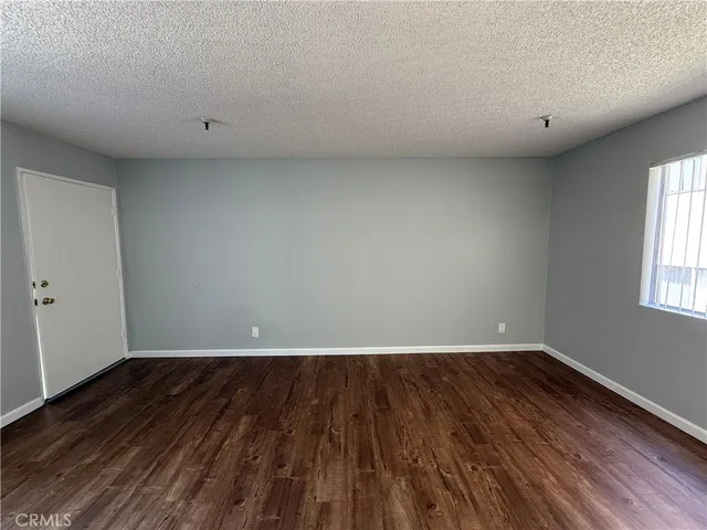 a view of room with wooden floor and window