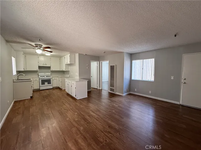 a view of a kitchen with stove and cabinets