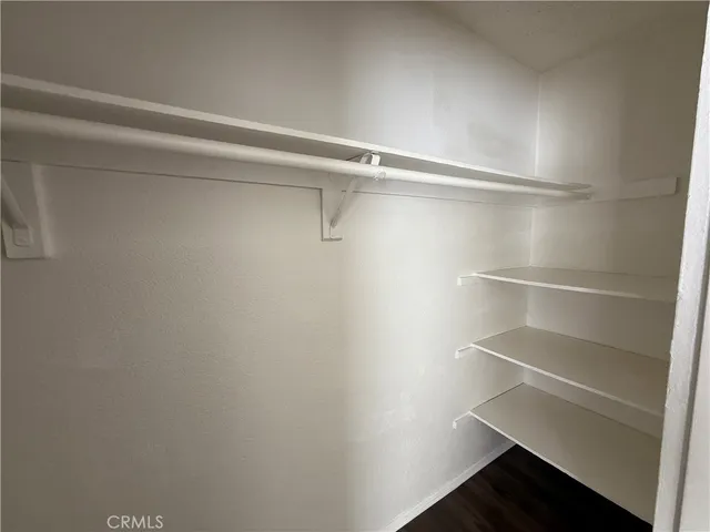 a view of walk in closet with empty racks
