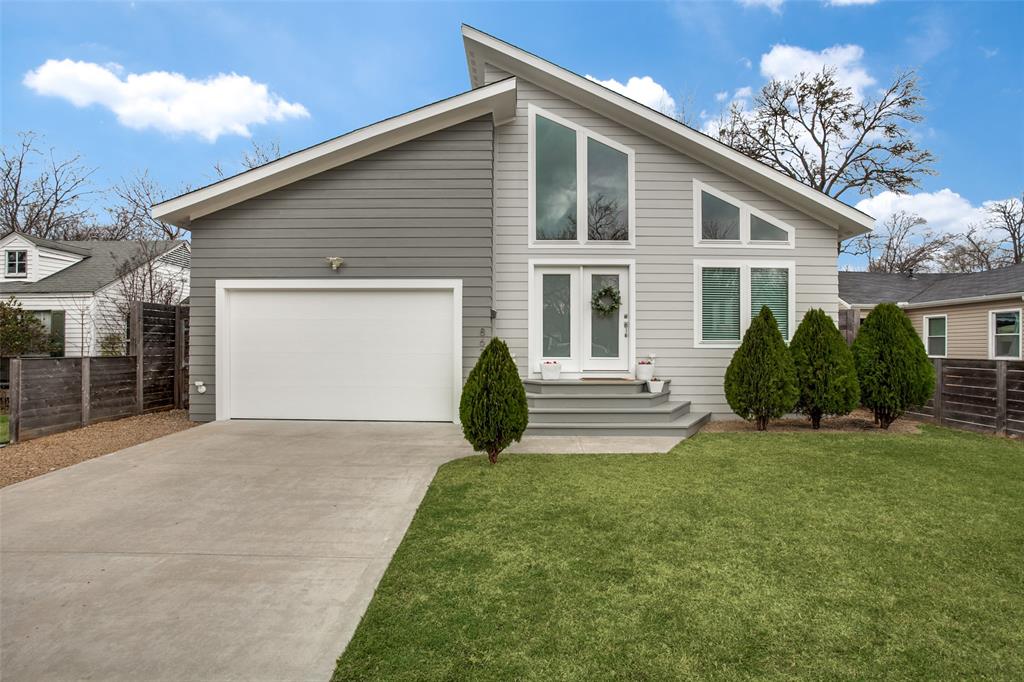 a view of a house with a yard and garage