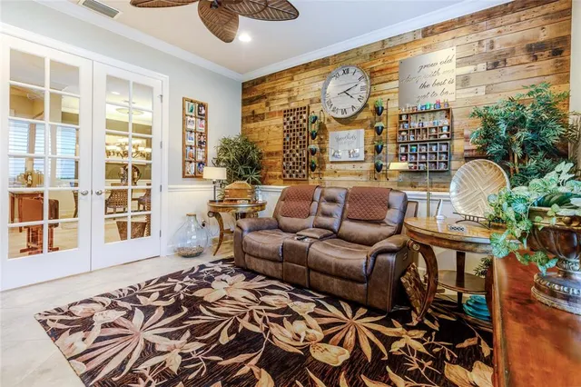 a living room with furniture chandelier and a large window