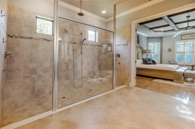 a living room with furniture kitchen view and a chandelier