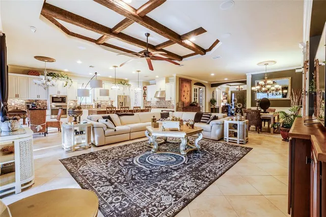 a kitchen with kitchen island granite countertop a table chairs sink and cabinets