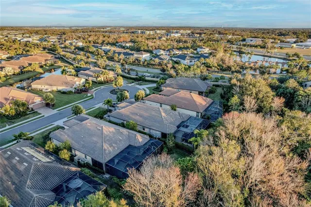 a living room with stainless steel appliances lots of white furniture and a table