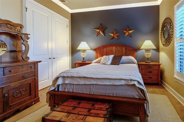 a bedroom with a bed and a clock on the wall