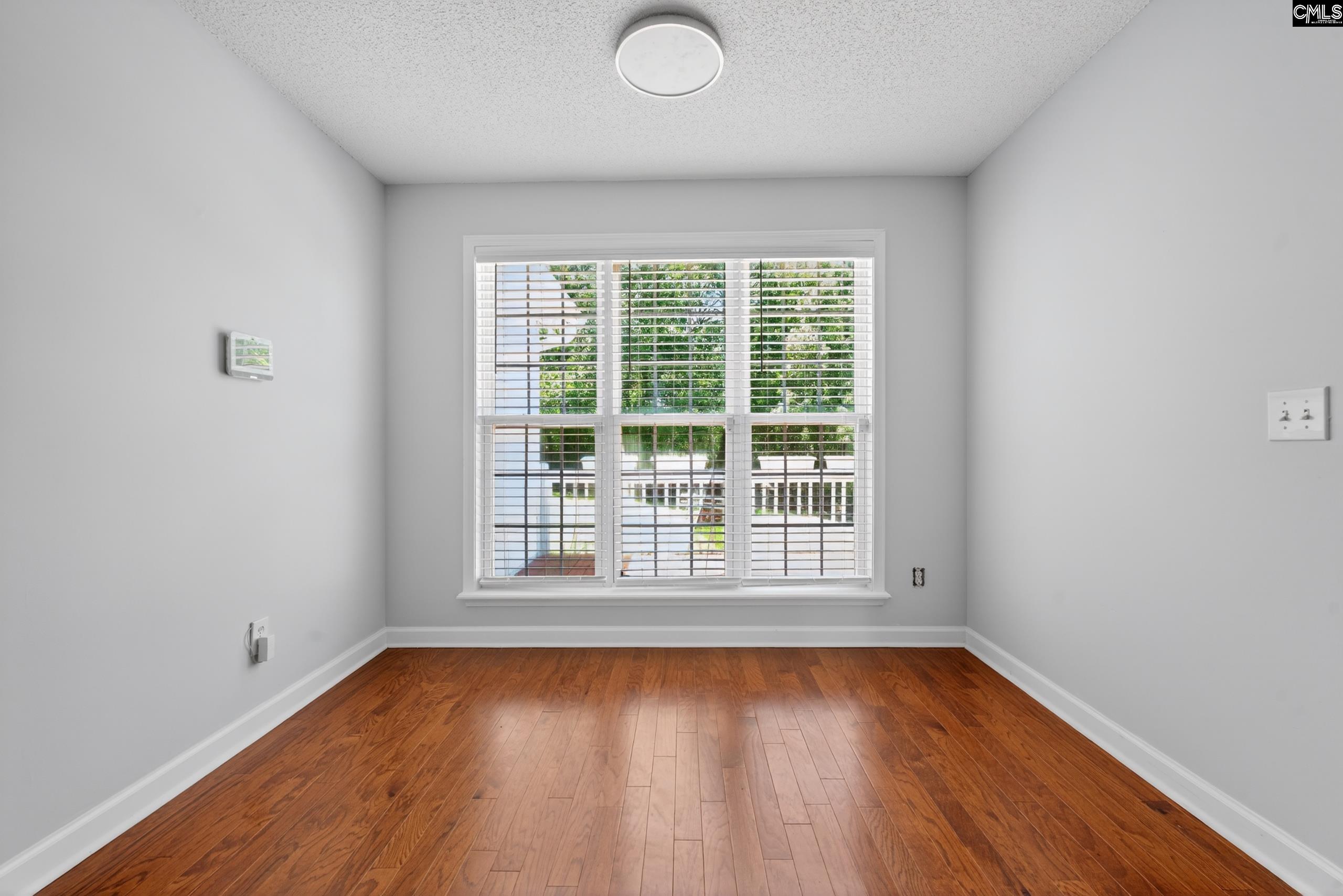 219 Plantation Pointe Drive Elgin, SC 29045 - Photo 35 of 56 an empty room with wooden floor and windows