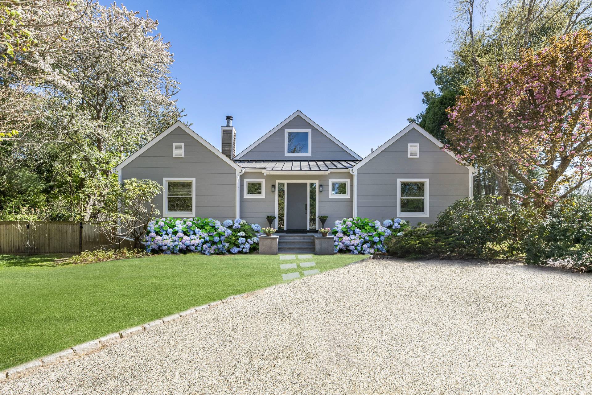 55 Hildreth Lane Bridgehampton, NY 11932 - Photo 1 of 21 a front view of a house with a yard and garage