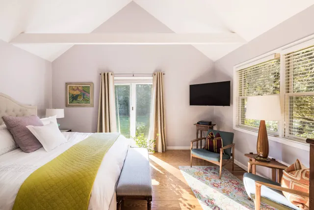 a bedroom with a bed and a flat screen tv