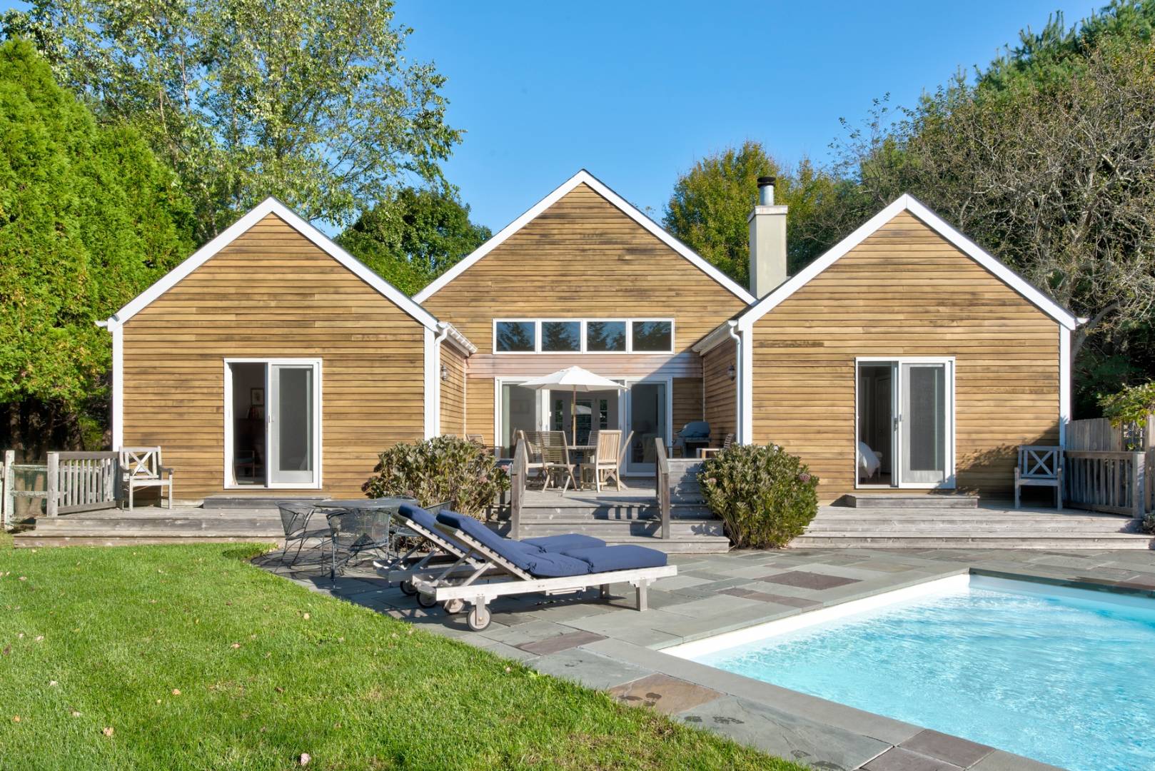 55 Hildreth Lane Bridgehampton, NY 11932 - Photo 2 of 21 a view of a house with a yard chairs and a table
