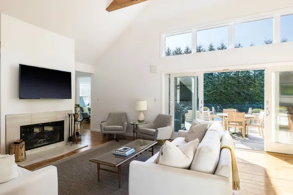 a living room with furniture a fireplace and a flat screen tv