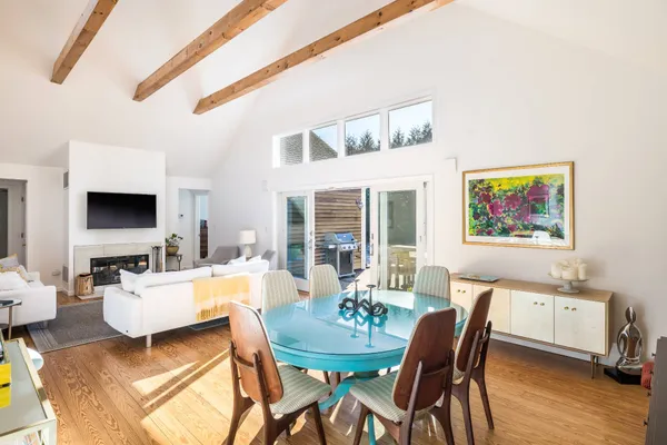 a living room with furniture a flat screen tv and a large window