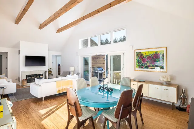 a living room with furniture a flat screen tv and a large window