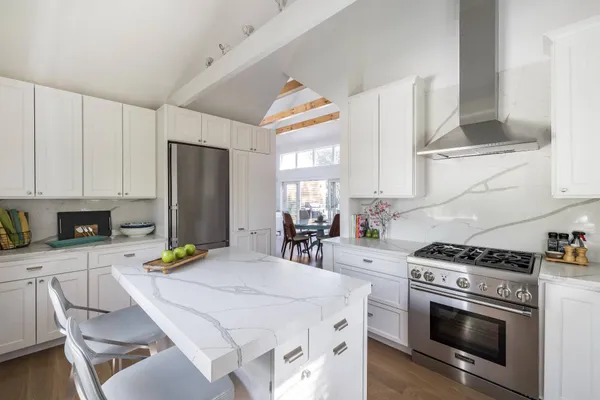 a kitchen with a stove a sink and a refrigerator