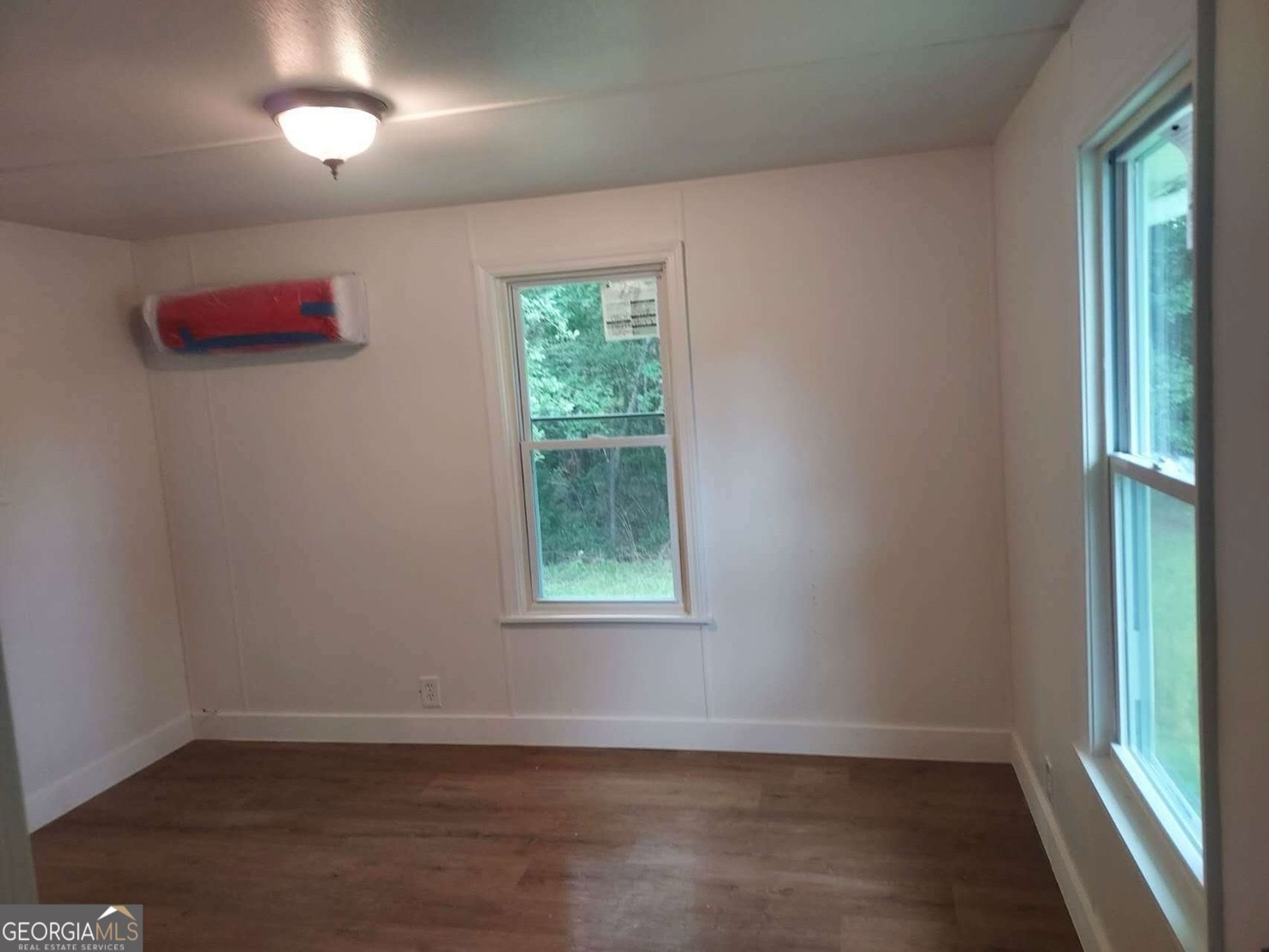 514 Phillips Road Warm Springs, GA 31830 - Photo 13 of 36 an empty room with wooden floor and windows